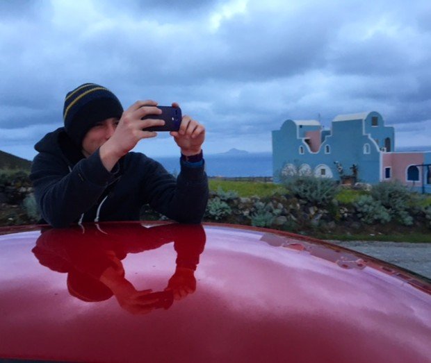 Kyle taking pictures in Santorini, Greece